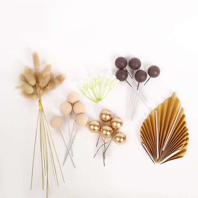 Decorative floral picks and leaves in neutral and gold tones on a white backdrop.