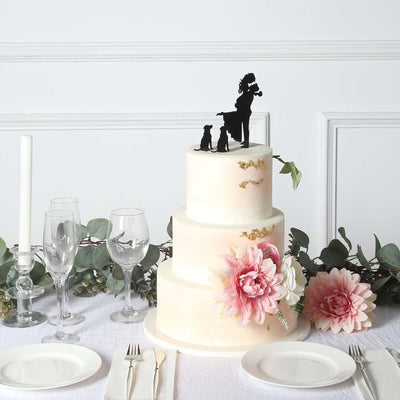 Elegant three-tier wedding cake with floral accents and a silhouette topper.