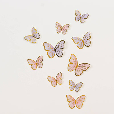 Colorful paper butterflies in various sizes and styles on a white background.