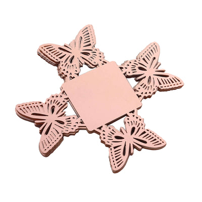 Butterfly-shaped coasters in rose gold color on a white background