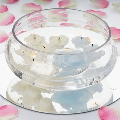 Floating candles in a clear glass bowl with rose petals around it.