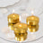 Gold tealight candles on a mirrored surface with rose petals.