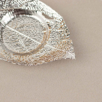 Silver leaf-shaped dish with intricate texture and detailing.