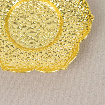 Decorative gold plate with intricate floral design.