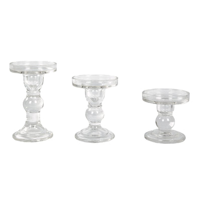 Set of three glass candle holders in varying heights.
