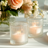 Elegant ribbed glass candle holders with soft glowing candles.