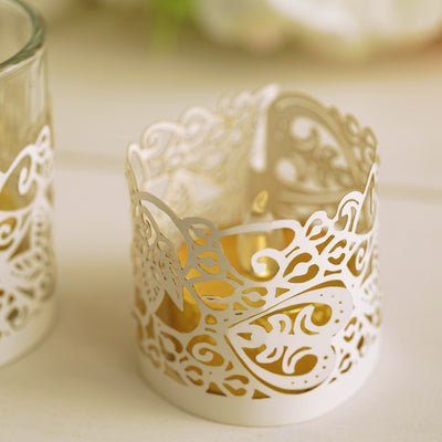 Decorative white candle holder with intricate heart design