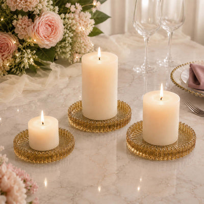 Elegant candlelit wedding table centerpiece with floral arrangement and gold holders