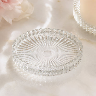 Elegant round glass decorative tray on a soft marble surface