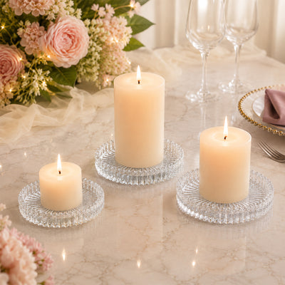 Elegant flameless candles on crystal holders with floral wedding table decor
