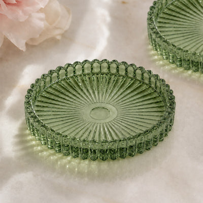 Green ribbed glass decorative plate on soft floral background