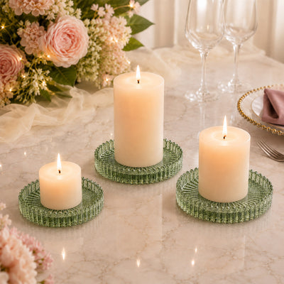 Elegant candle centerpiece on marble table with flowers and glassware