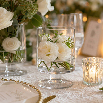 Elegant white floral centerpiece in glass vase on a wedding reception table