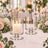 Elegant glass candle holders on a floral wedding reception table centerpiece