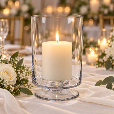 Elegant candle in glass hurricane vase on a wedding table centerpiece