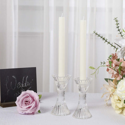 Elegant crystal candle holders with white candles and floral decor