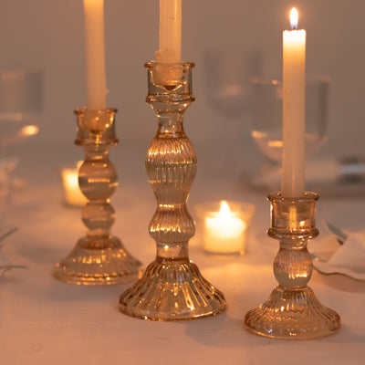 Elegant glass candle holders with lit candles, creating a warm ambiance.