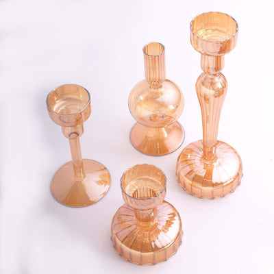 Set of four elegant amber glass candle holders