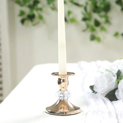 Elegant candle holder with crystal accent and white candle.