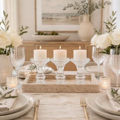Elegant neutral tablescape with white roses, candles, and gold flatware