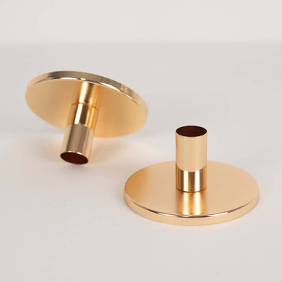 Gold candle holder set on a plain background