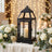 Black lantern candle centerpiece with white roses and fairy lights