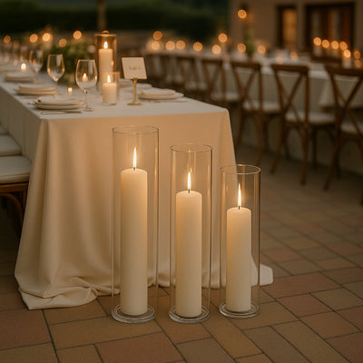 Elegant candles in glass holders illuminate a beautifully set dining table.