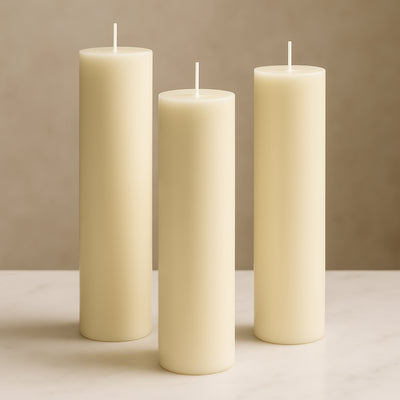 Set of three ivory pillar candles in varying heights.