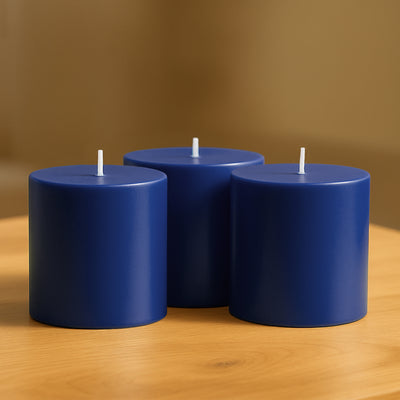 Blue cylindrical candles on a wooden table.