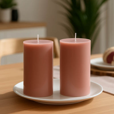 Pink candles on a white plate in a cozy kitchen setting.