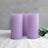 Lavender pillar candles arranged with greenery accent