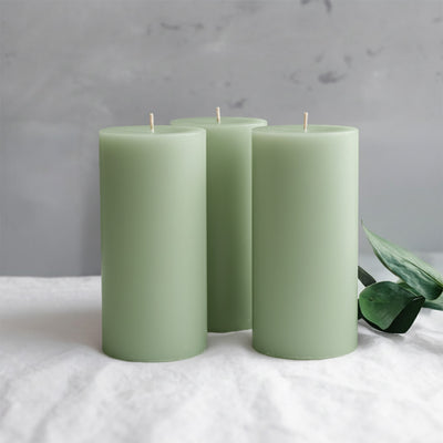 Set of three green pillar candles with a minimalist design.