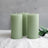 Set of three green pillar candles with a minimalist design.