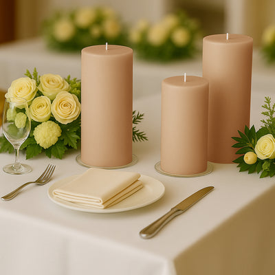 Elegant beige candles on a dining table with floral arrangements and tableware.