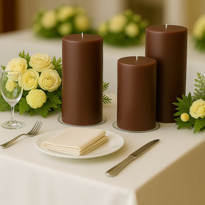 Brown candles on a table set with flowers and dinnerware.