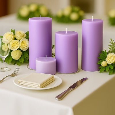 Purple candles arranged elegantly on a table with flowers and tableware.