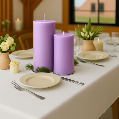 Purple candles on a beautifully set dining table with floral decorations.