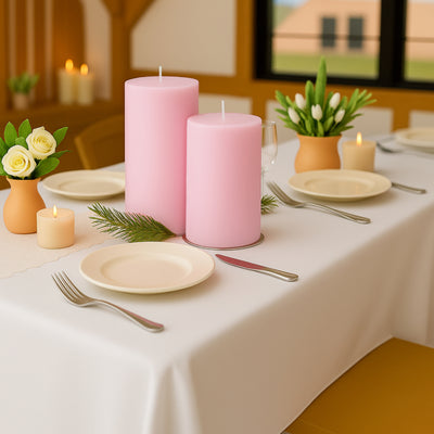 Elegant table setting with pink candles, flowers, and dinnerware.