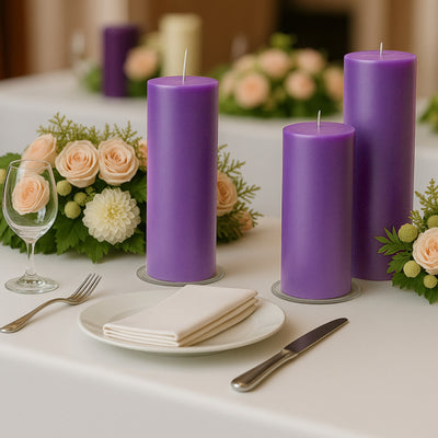 Purple candles on a table with flowers and dining setup.