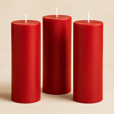 Set of three red pillar candles in varying heights.