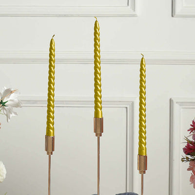 Yellow twisted candles in elegant holders