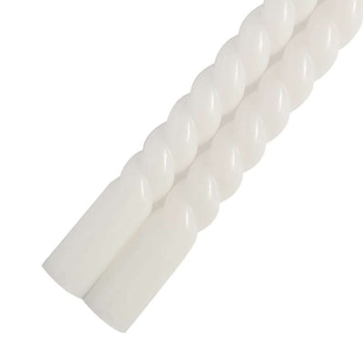 White twisted candle pair on plain background