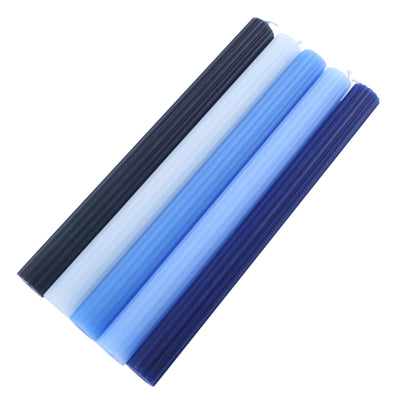 Assorted decorative candles in blue and black colors on a white background