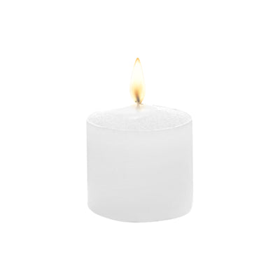 White candle with flame on a plain background