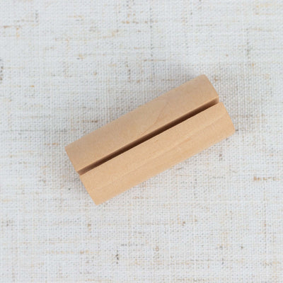 Wooden crafting block with a groove for easy manipulation.