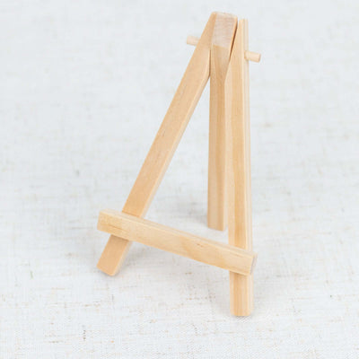 Wooden easel for displaying small artworks or photos.