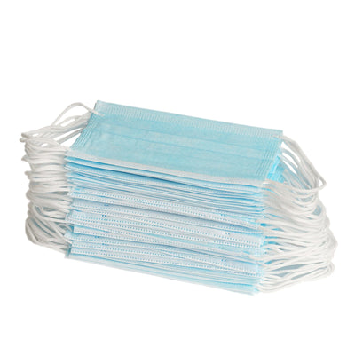 Stack of blue disposable face masks on a white background.