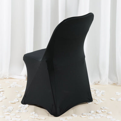 Black chair cover on a white backdrop with scattered rose petals.