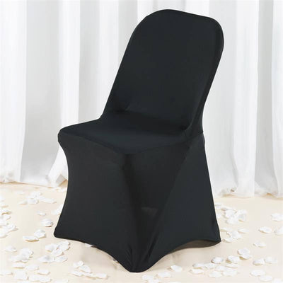 Black fitted chair cover on a white backdrop with scattered petals.
