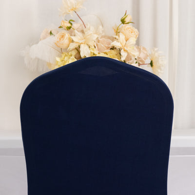 Navy blue chair cover with floral arrangement in the background.